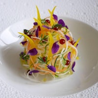 a white plate with a colorful salad on it