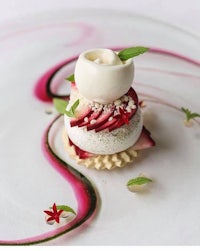 a dessert with strawberries and cream on a white plate