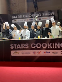 a group of chefs posing for a photo at the stars cooking show