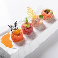 a plate of sushi on a white plate