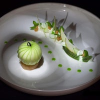 a white plate with a green apple on it